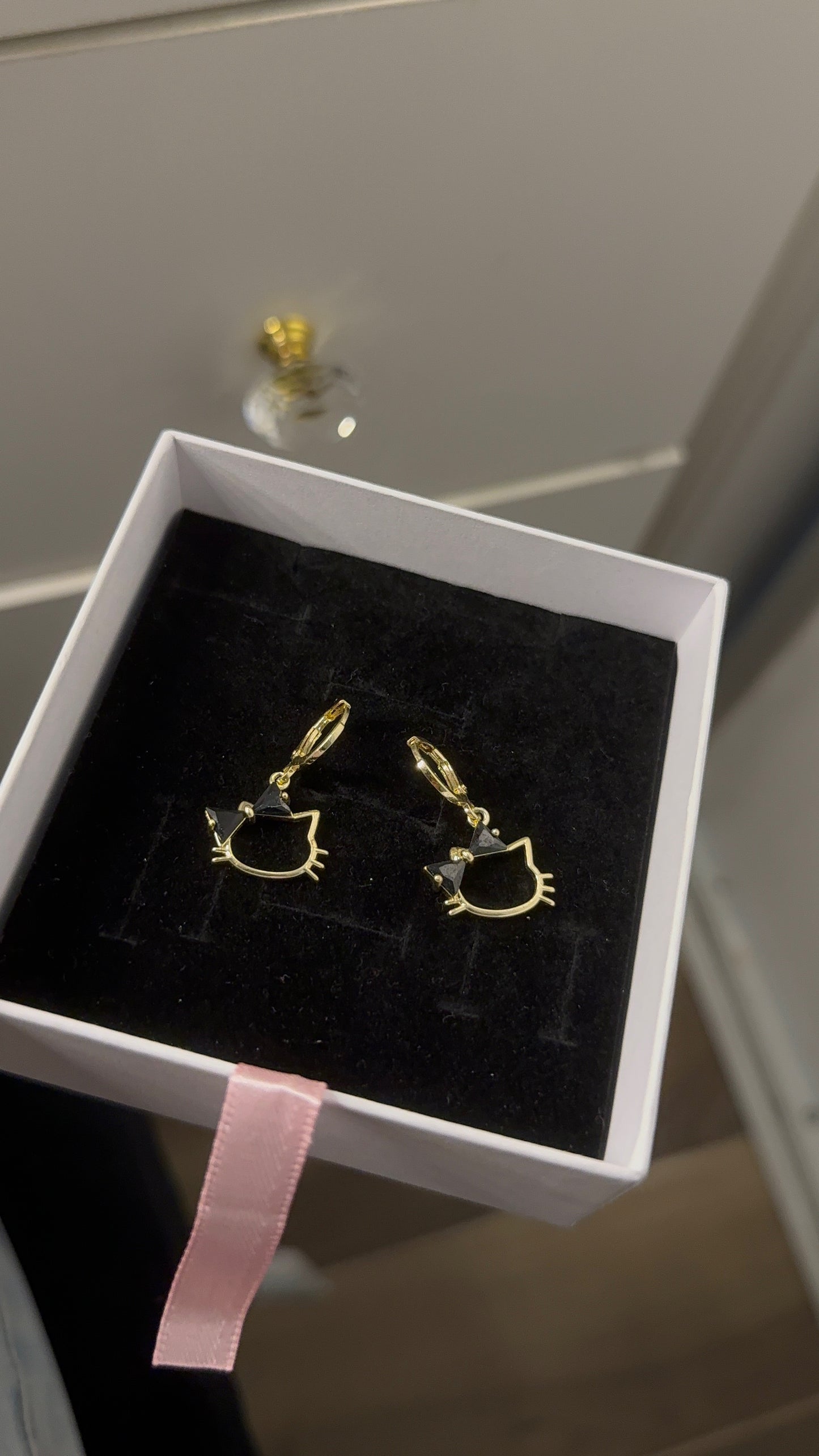 Black Hk Huggie earrings